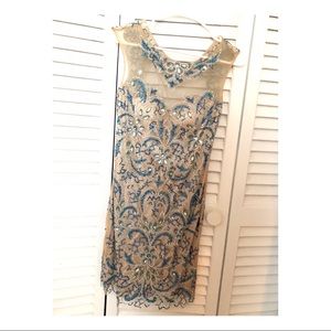 Nude dress with blue and silver stones and cut out back. Absolutely stunning!